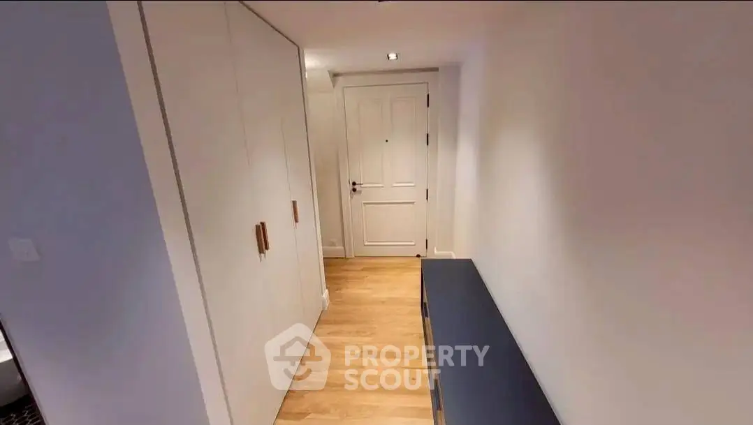 Modern hallway with wooden flooring and sleek storage solutions