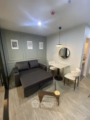 Modern living room with stylish furniture and elegant decor in a cozy apartment setting.