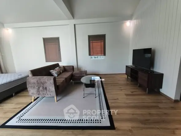 Spacious living room with modern furniture and sleek wooden flooring