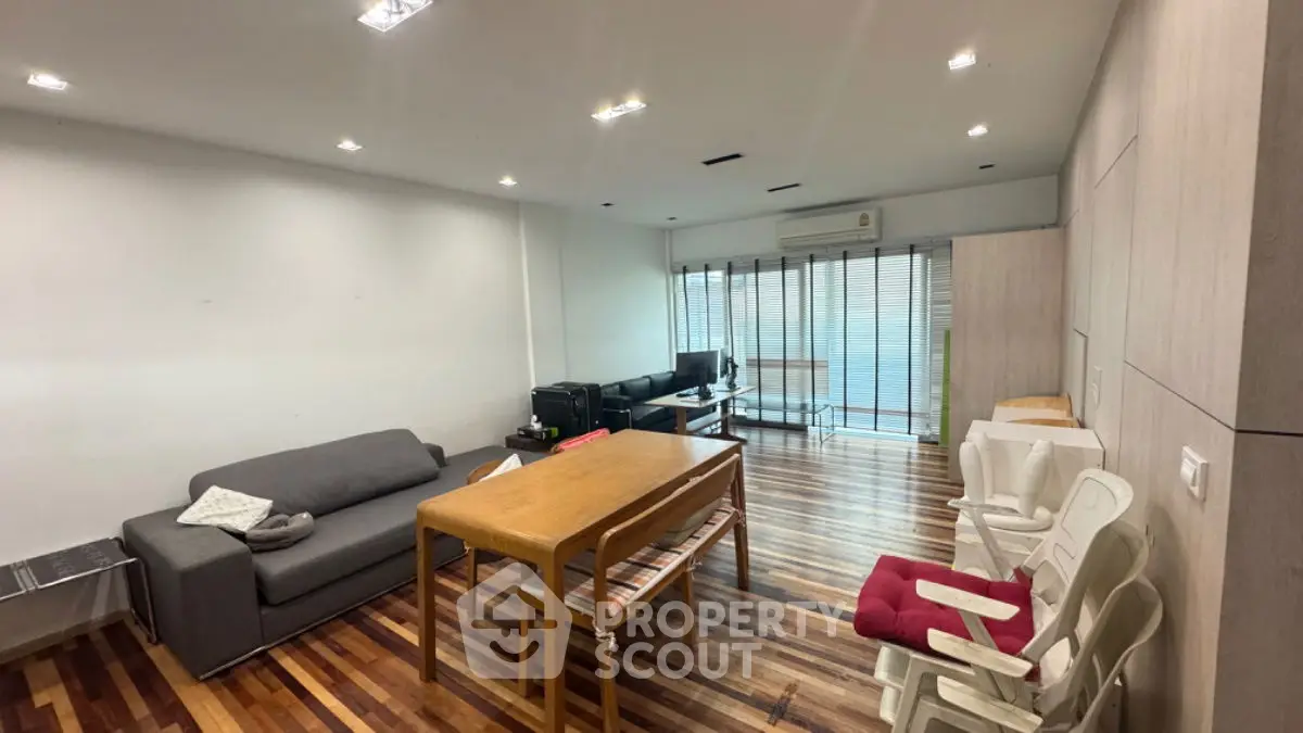 Spacious living room with modern furniture and wooden flooring