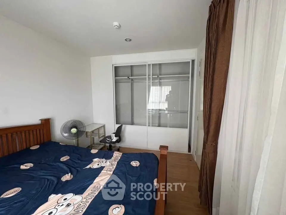 Cozy bedroom with wooden bed frame and sliding closet doors, perfect for a restful retreat.