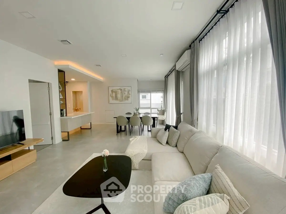 Spacious modern living room with elegant decor and large windows