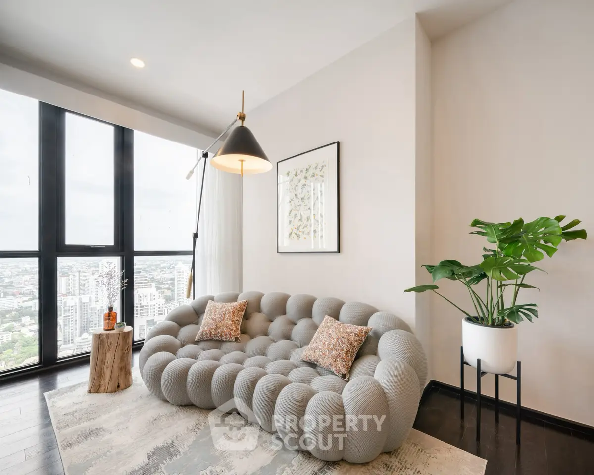 Stylish modern living room with unique sofa and panoramic city view.