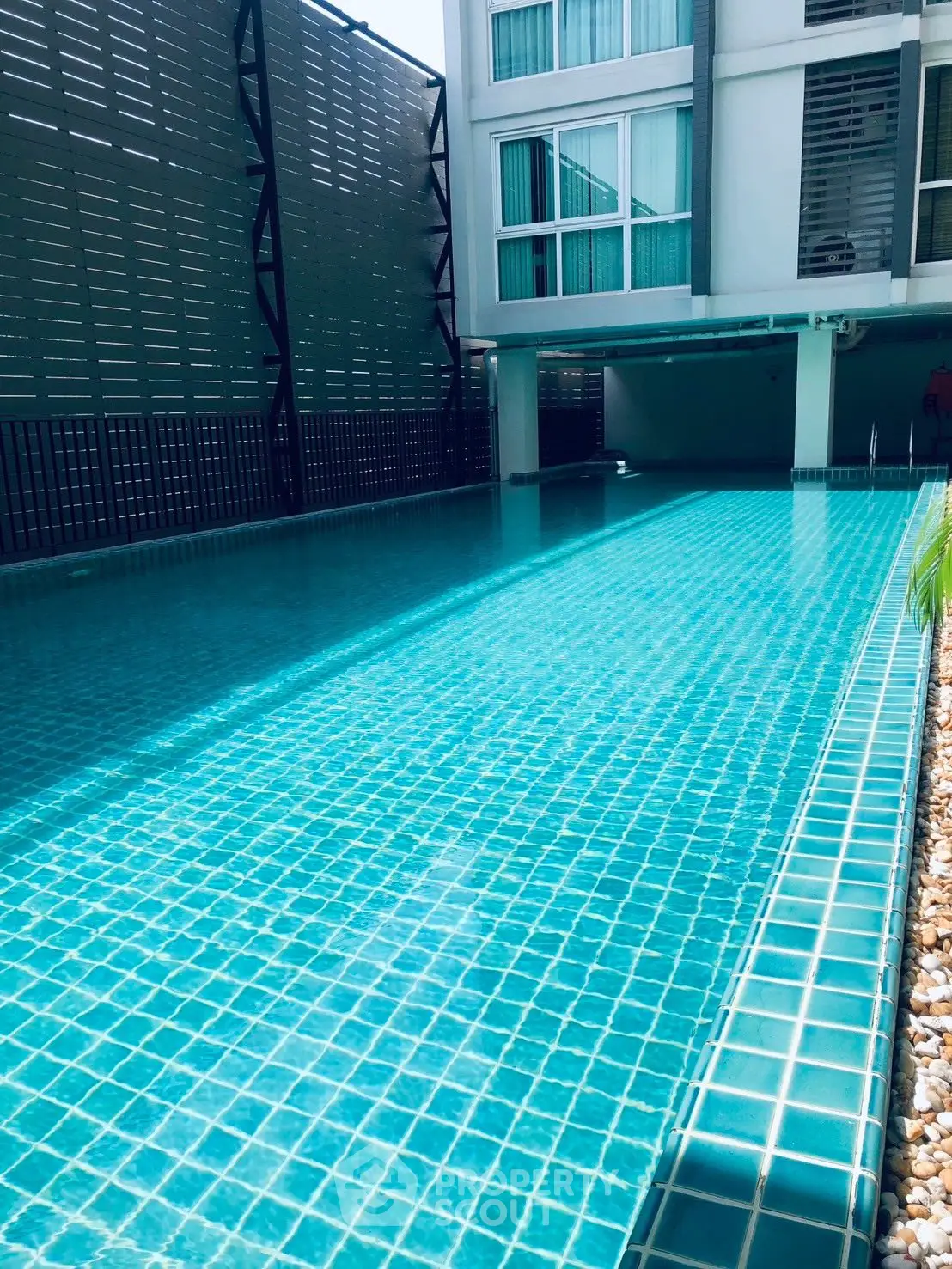 Luxurious condominium pool with modern design and serene ambiance, perfect for relaxation and leisure.