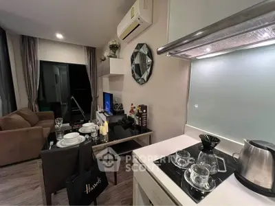 Modern living room with open kitchen, stylish decor, and cozy ambiance in a contemporary apartment.