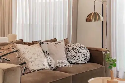Elegant living room with plush sofa and stylish decor accents.