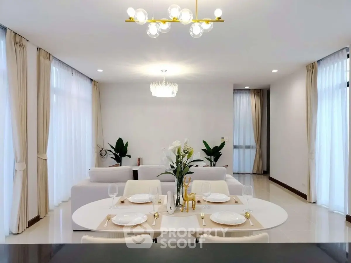 Elegant open-plan living and dining area with modern decor and natural light.
