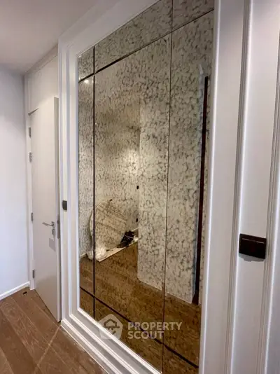 Elegant hallway with mirrored closet doors and modern design