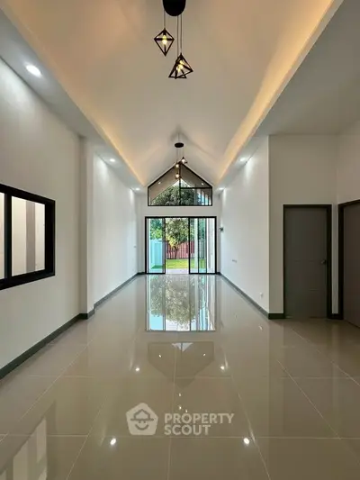 Spacious modern living room with high ceilings and large windows offering natural light.