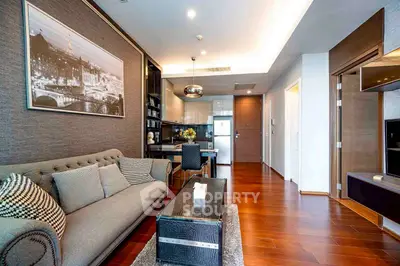 Modern living room with elegant decor and open kitchen layout in a stylish apartment.