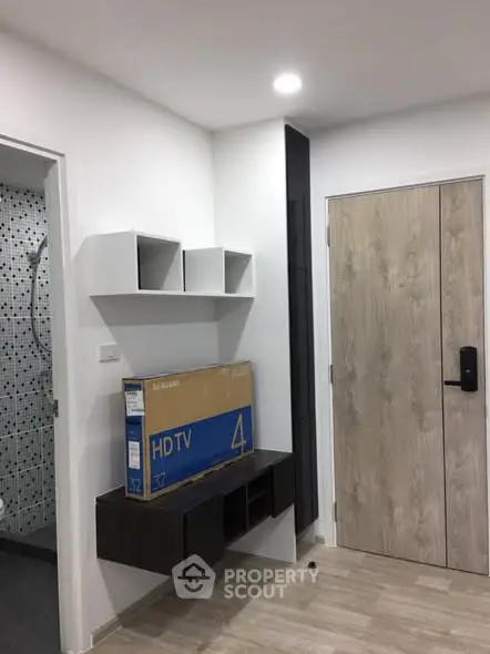 Modern apartment entrance with stylish shelving and wooden door