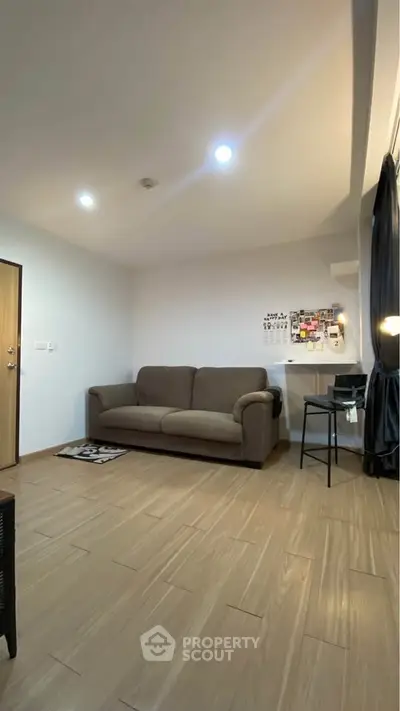 Modern living room with cozy sofa and stylish decor, perfect for relaxation and entertaining.