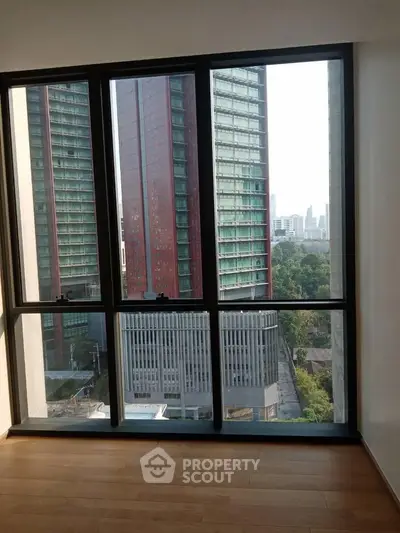 Stunning cityscape view from a modern apartment window, showcasing urban living with natural light.