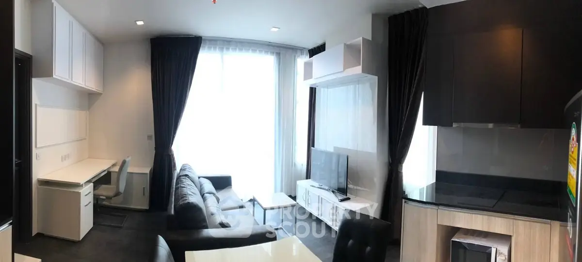 Modern living room with sleek furniture and large window, perfect for urban living.