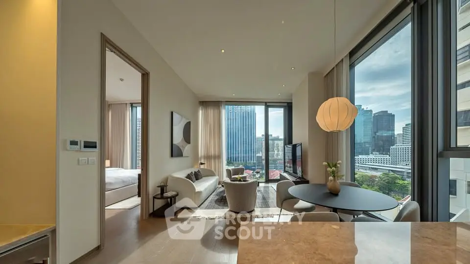 Luxurious modern living room with city view, open layout, and elegant furnishings in high-rise apartment.