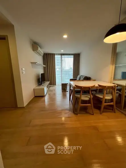 Spacious living room with modern furniture and large window offering natural light.