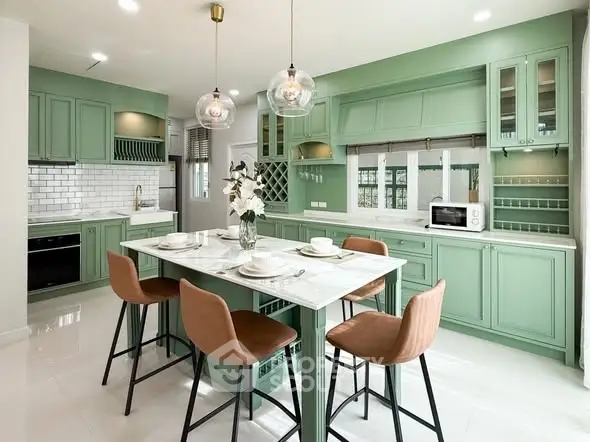 Charming kitchen with mint green cabinets and modern dining area