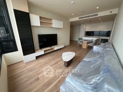 Modern living room with sleek furniture and open kitchen layout