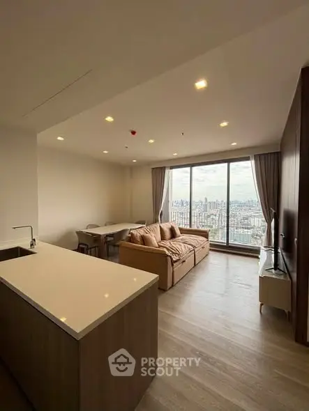 Spacious modern living room with panoramic city view and elegant furnishings.