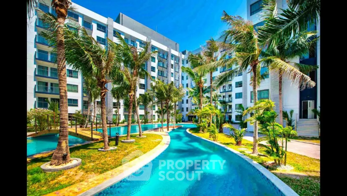 Luxurious apartment complex with stunning pool and lush palm trees