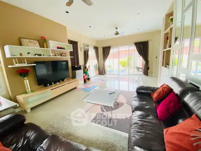 Spacious living room with modern decor and large windows offering natural light.
