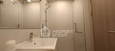 Modern bathroom with sleek fixtures and glass shower enclosure