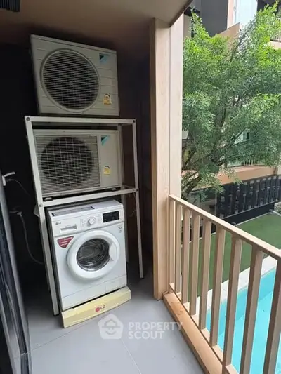 Modern balcony with washing machine and pool view, perfect for urban living.