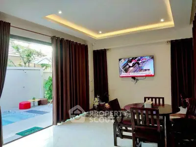 Modern living room with pool view and elegant dining area