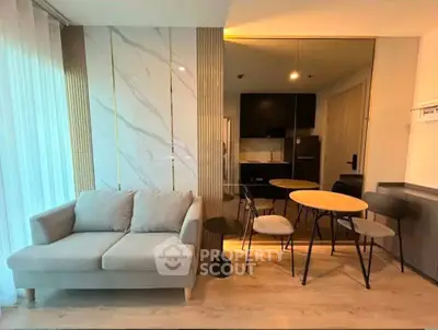Modern living room with stylish dining area and cozy sofa in open layout apartment.