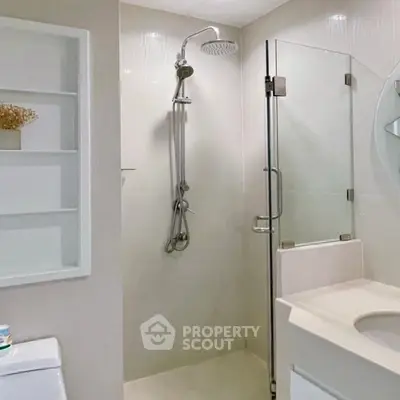 Modern bathroom with glass shower and sleek fixtures