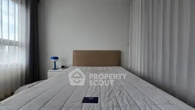 Modern bedroom with large window and minimalist decor