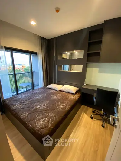 Modern bedroom with balcony view and workspace in stylish apartment