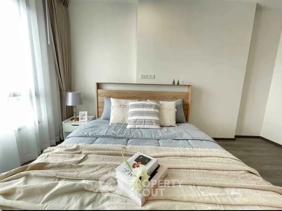 Cozy bedroom with stylish decor and natural light, perfect for relaxation and comfort.