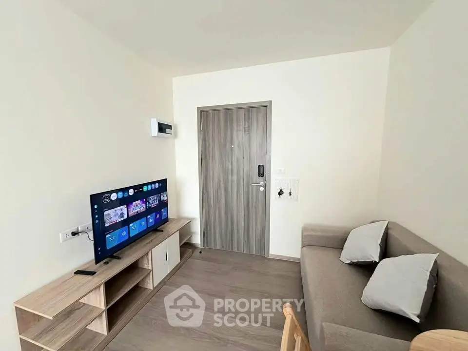 Modern living room with sleek furniture and smart TV, ideal for cozy relaxation.