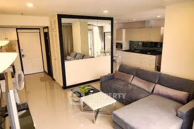 Modern living room with sleek design and open kitchen layout in a stylish apartment.