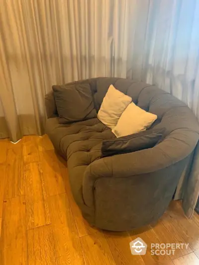 Cozy living room corner with plush sofa and elegant wooden flooring