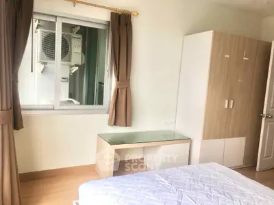 Bright bedroom with window view and modern furniture in a cozy apartment.