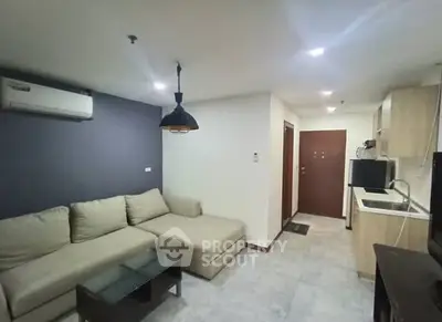 Modern living room with cozy sectional sofa and compact kitchen area