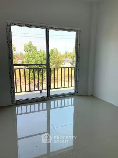 Bright room with large window and balcony view, perfect for natural light lovers.