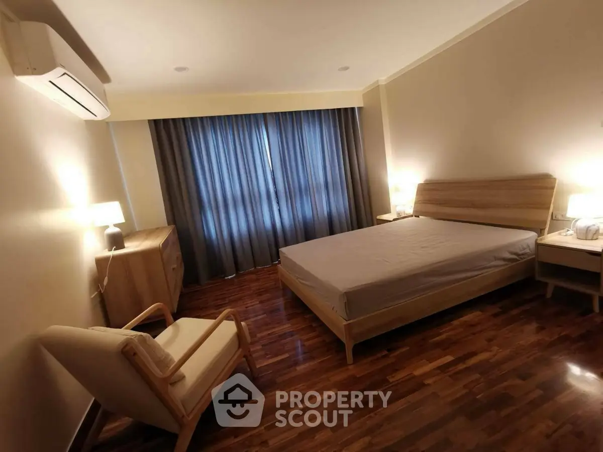 Spacious bedroom with modern wooden furniture and elegant lighting