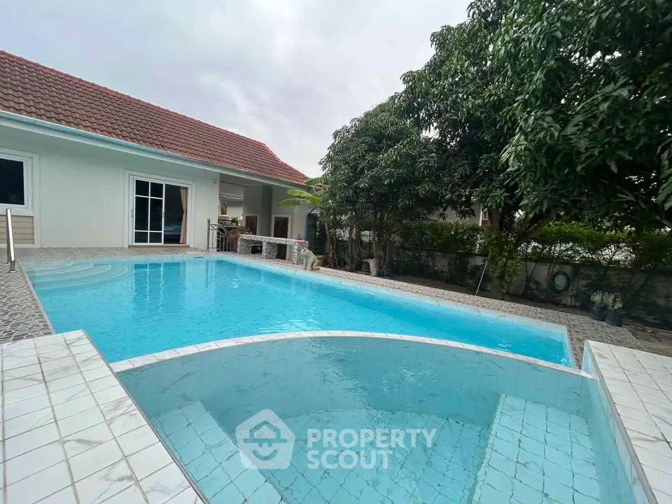 Charming property with inviting swimming pool and lush greenery, perfect for relaxation and outdoor enjoyment.