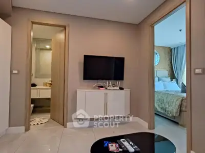 Modern apartment interior with TV, bathroom, and bedroom view