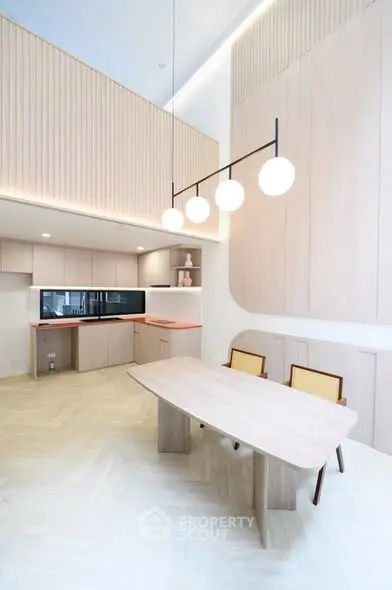 Modern kitchen with open layout and stylish dining area in a contemporary apartment.