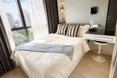 Modern bedroom with large window and stylish decor in urban apartment