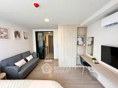 Modern studio apartment with stylish decor, featuring a cozy living area, sleek kitchen, and contemporary furnishings.