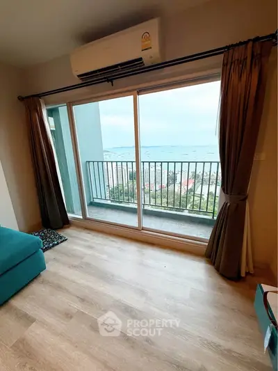 Modern apartment with balcony offering stunning ocean view and natural light.
