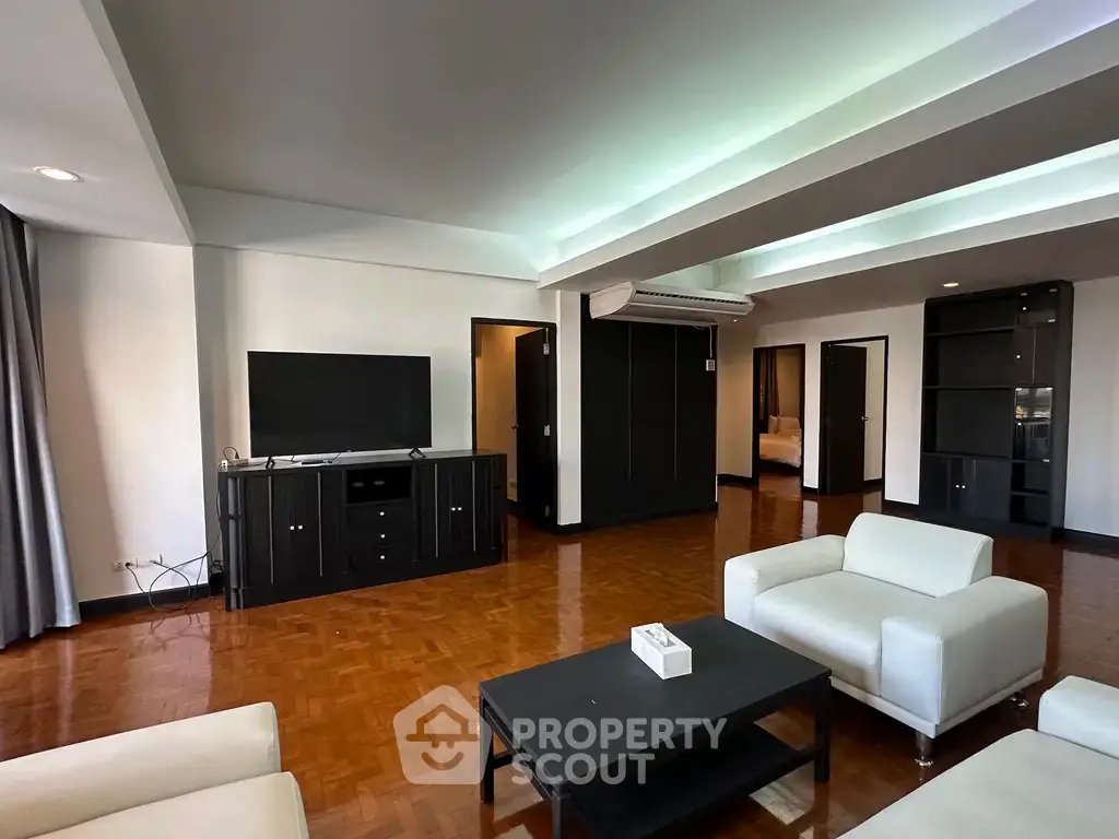 Spacious modern living room with sleek furniture and elegant wooden flooring