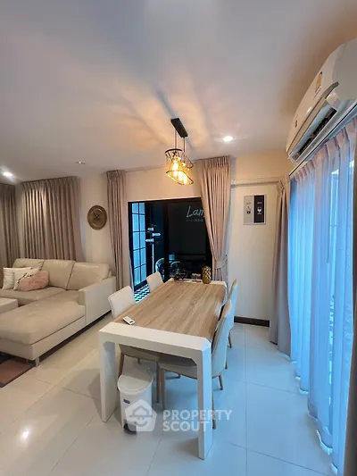 Modern living room with elegant dining area and stylish lighting in a cozy apartment.