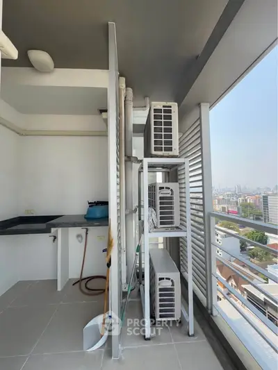 High-rise balcony with city view and air conditioning units, perfect for urban living.