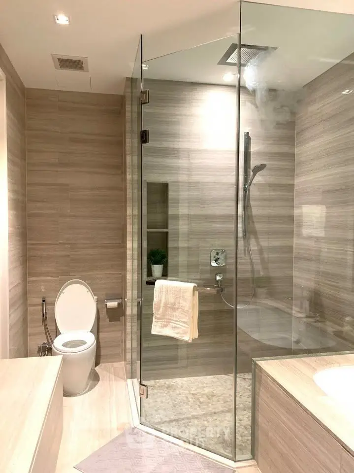 Luxurious modern bathroom with glass shower and elegant tile design